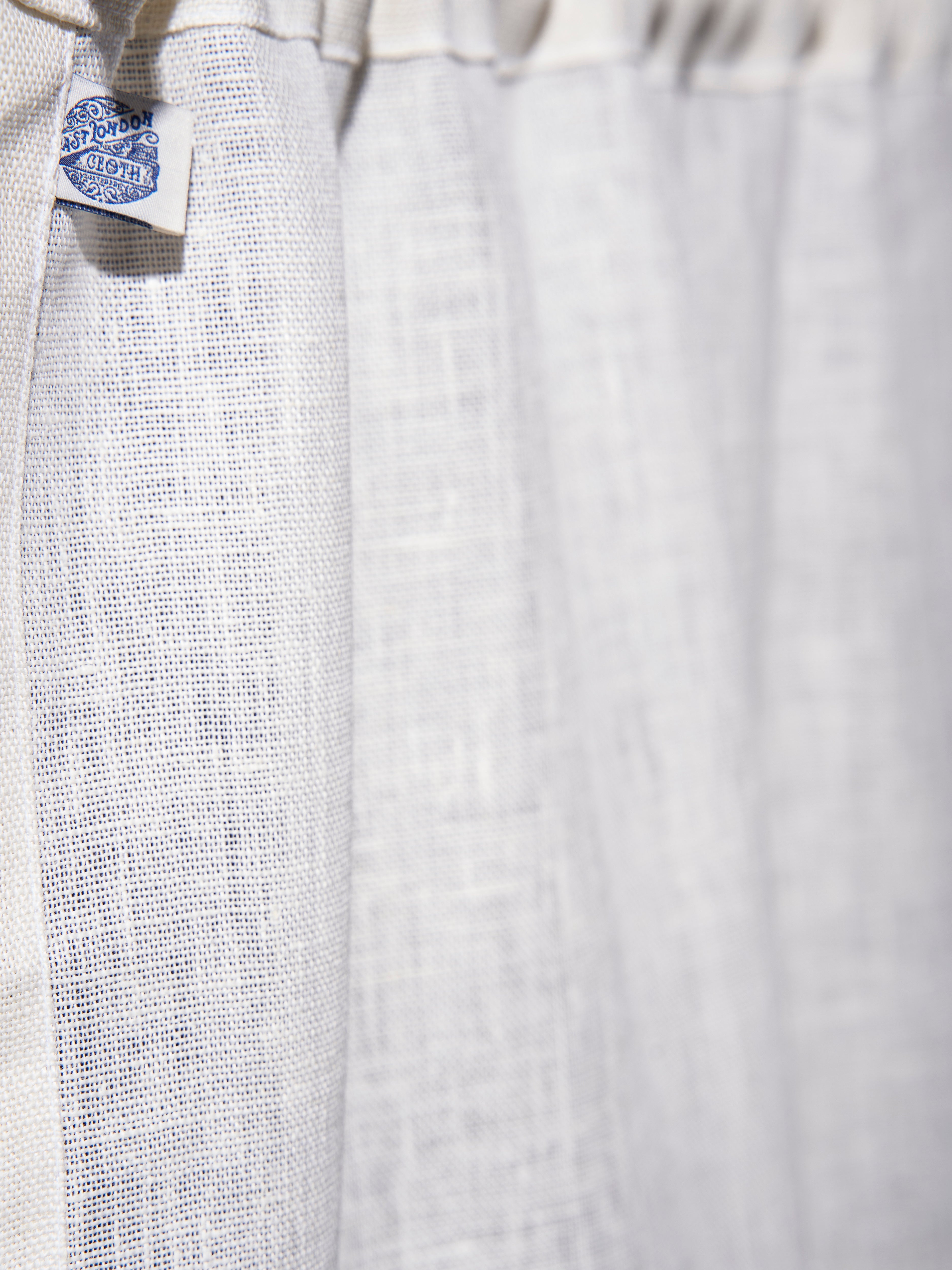 The cafe curtain - open weave Netto linen with a pocket top